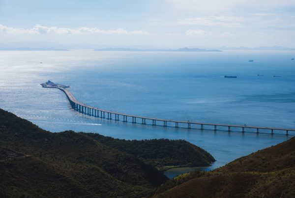 Scenic aerial view of the Hong Kong-Zhuhai-Macau Bridge spanning over tranquil waters.